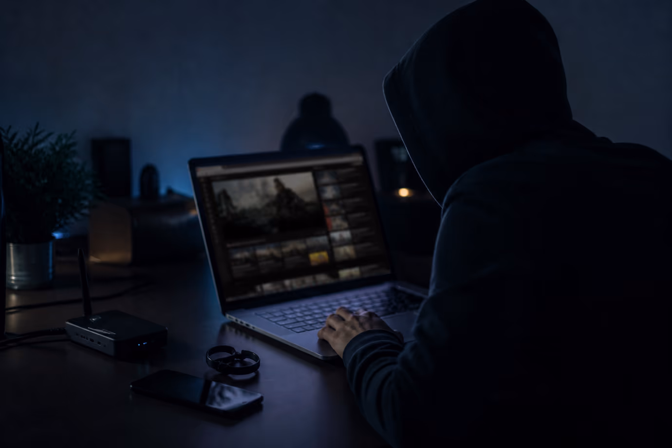 A user is exploring unique dark web video sites from their laptop in a dimly lit room.