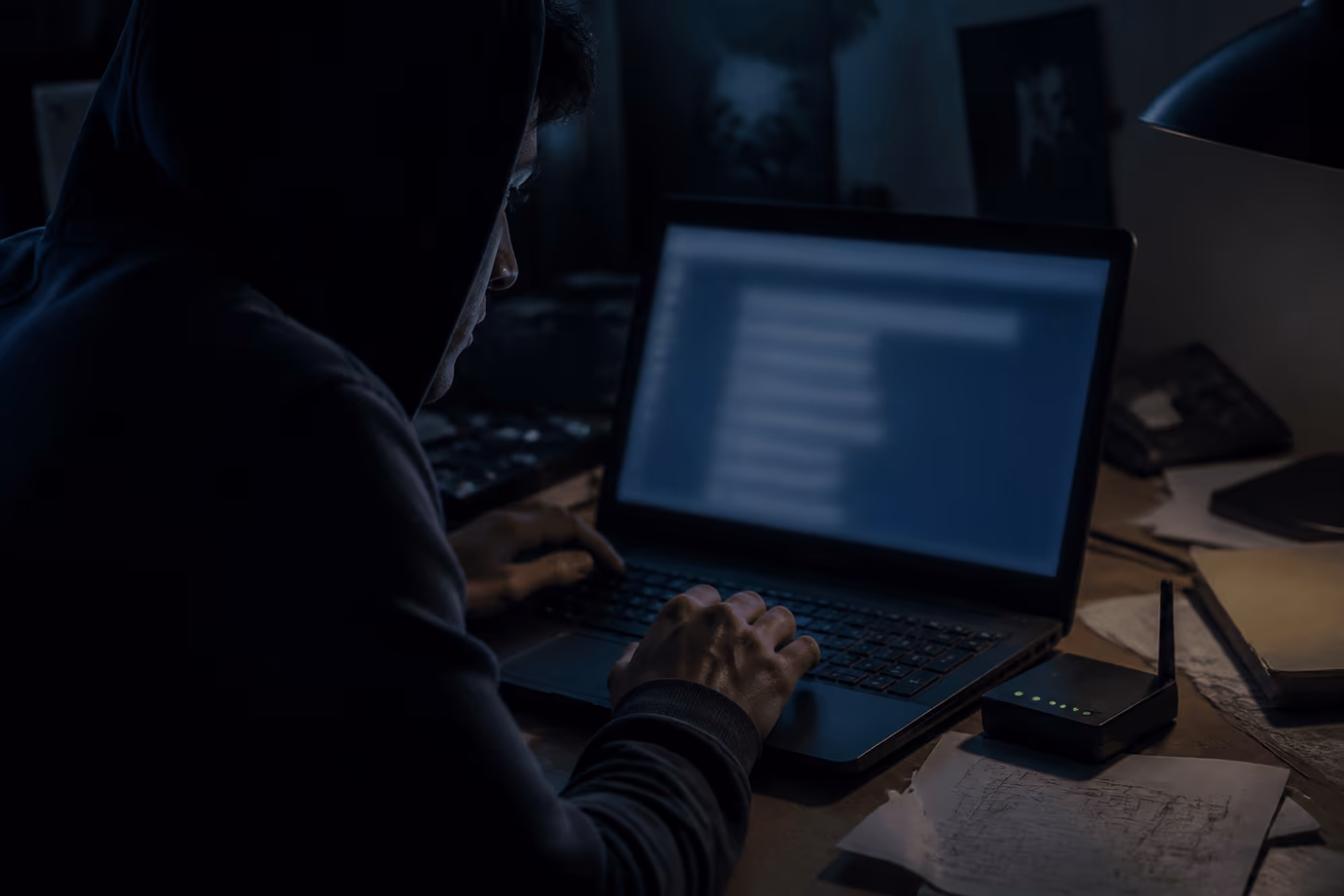 A person focused on browsing the Hidden Wiki in a dimly lit room.